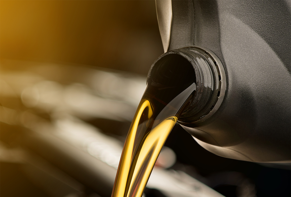 Close-up of motor oil pouring into a car during an oil change