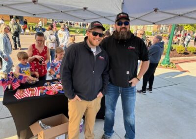 Two Pro Motors Service team members at a Memorial Day community event.