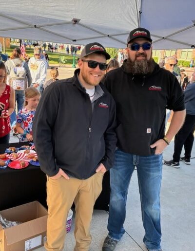 Two Pro Motors Service team members at a Memorial Day community event.