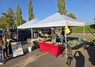 Pro Motors Service booth and dessert table at a tailgate.