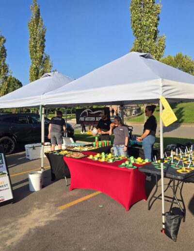 Pro Motors Service booth and dessert table at a tailgate.